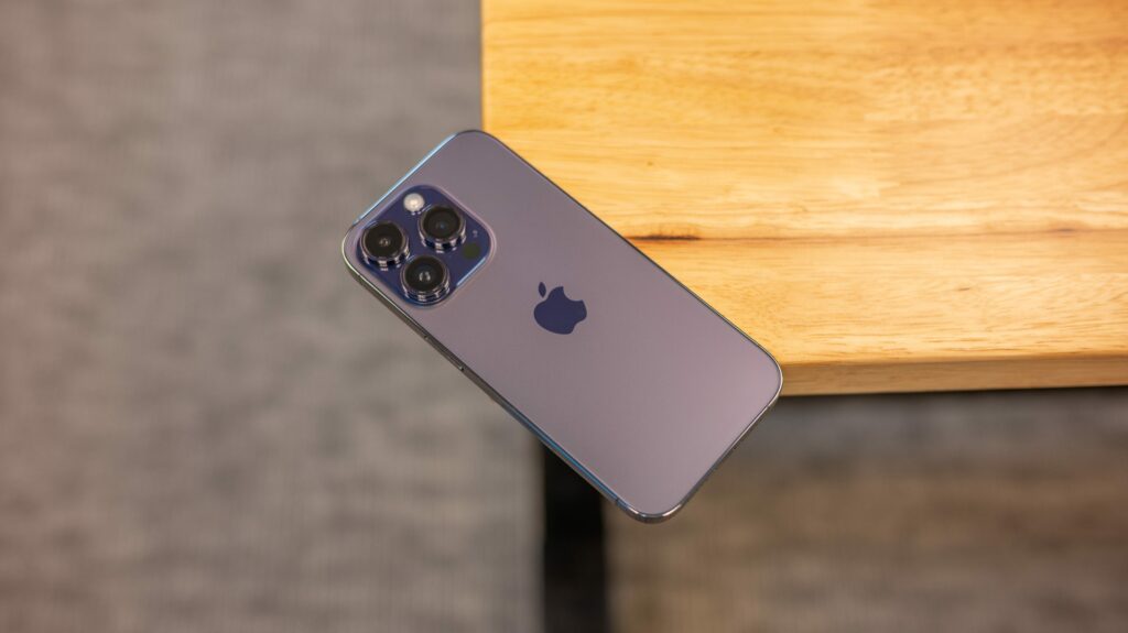 Purple Apple iPhone 14 Pro sitting on a desk